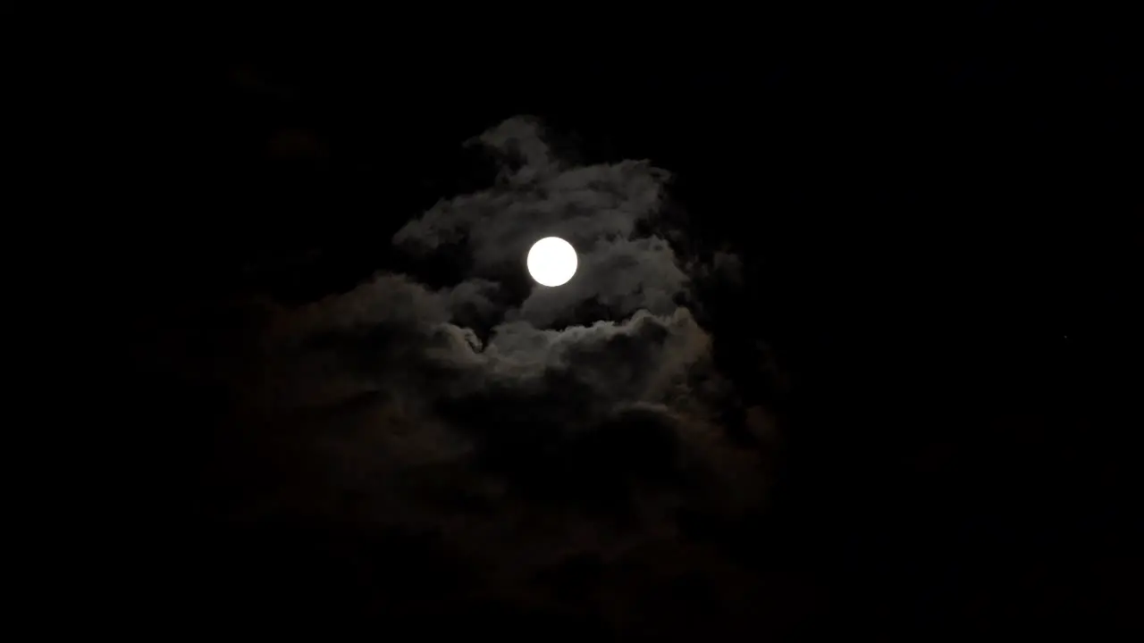 Moon disc and clouds at dark night sky timelapse fear mystery concept scene