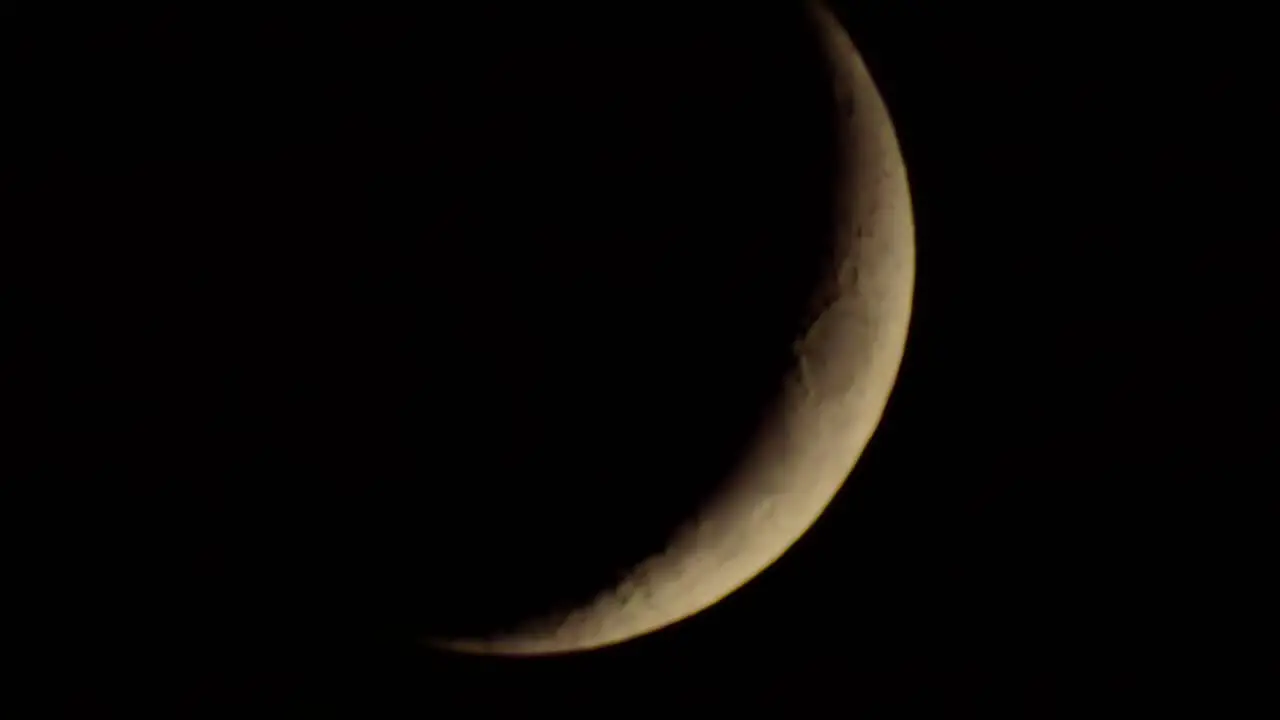 Dark dramatic glowing moon with fast moody clouds stormy passing across