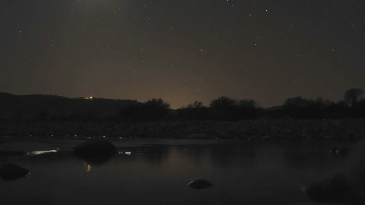 Time lapse of crescent moon and stars setting over the Ventura River in Oak View California