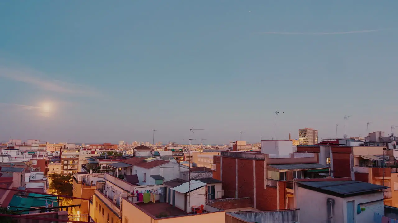 Moonrise Over The City And The Roofs Of Houses Timelapse From Evening To Dawn The Sun Rises Over The