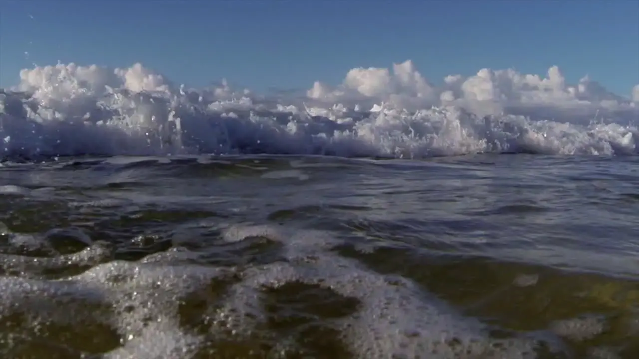 POV shot of slow motion waves crashing into shore including underwater perspective 3