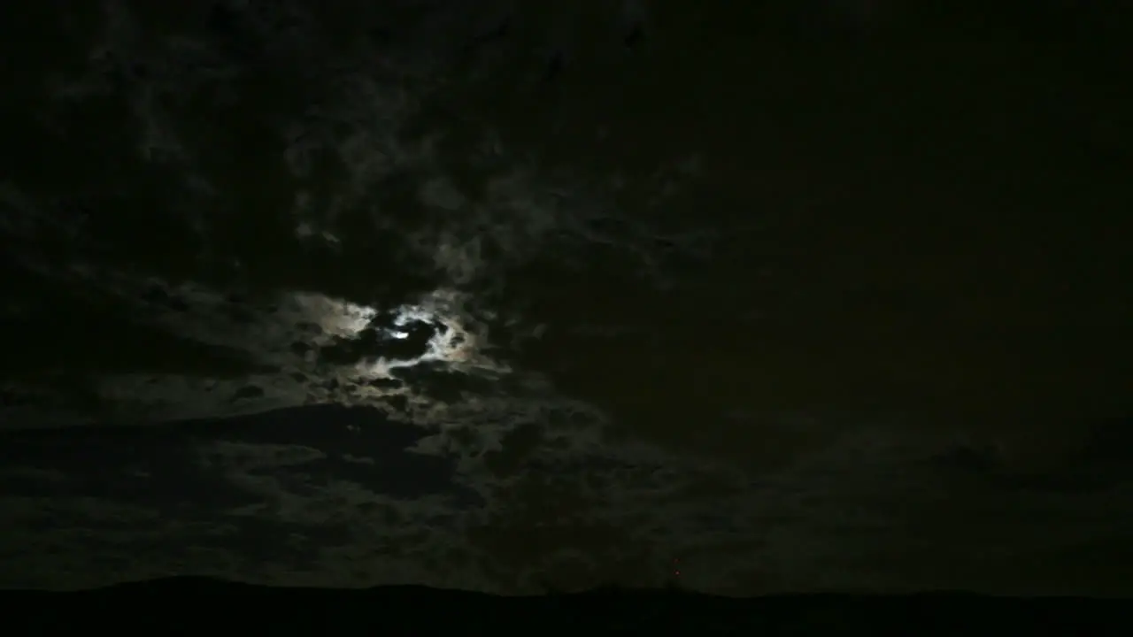 Dark clouds move across the moon in this haunting scene