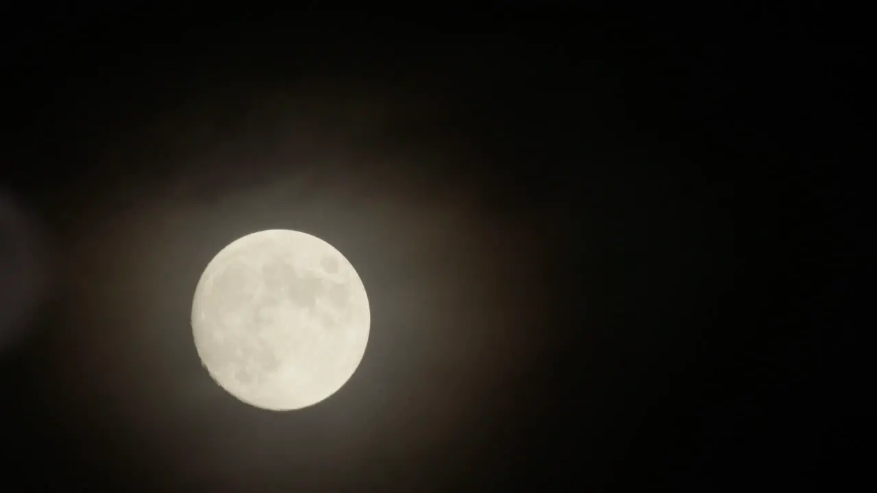 Full moon behind the cloud in nighttime