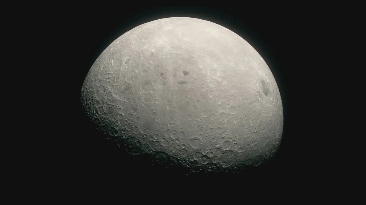 In the darkness of outer space the crater covered surface of the Moon can be seen slowly rotating