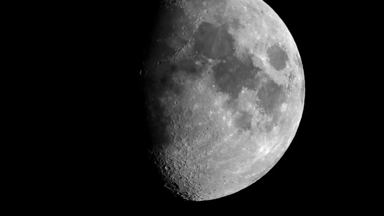 A time-lapse of the moon going across the pale blue of the evening sky