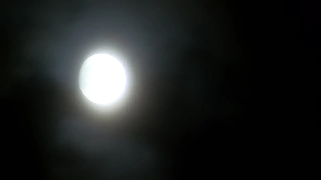 Full moon light in fast clouds at night time lapse