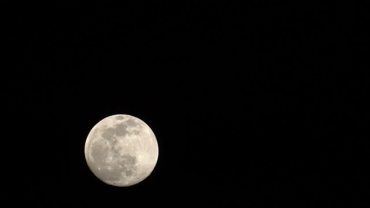 The beautiful full moon rising in the night sky