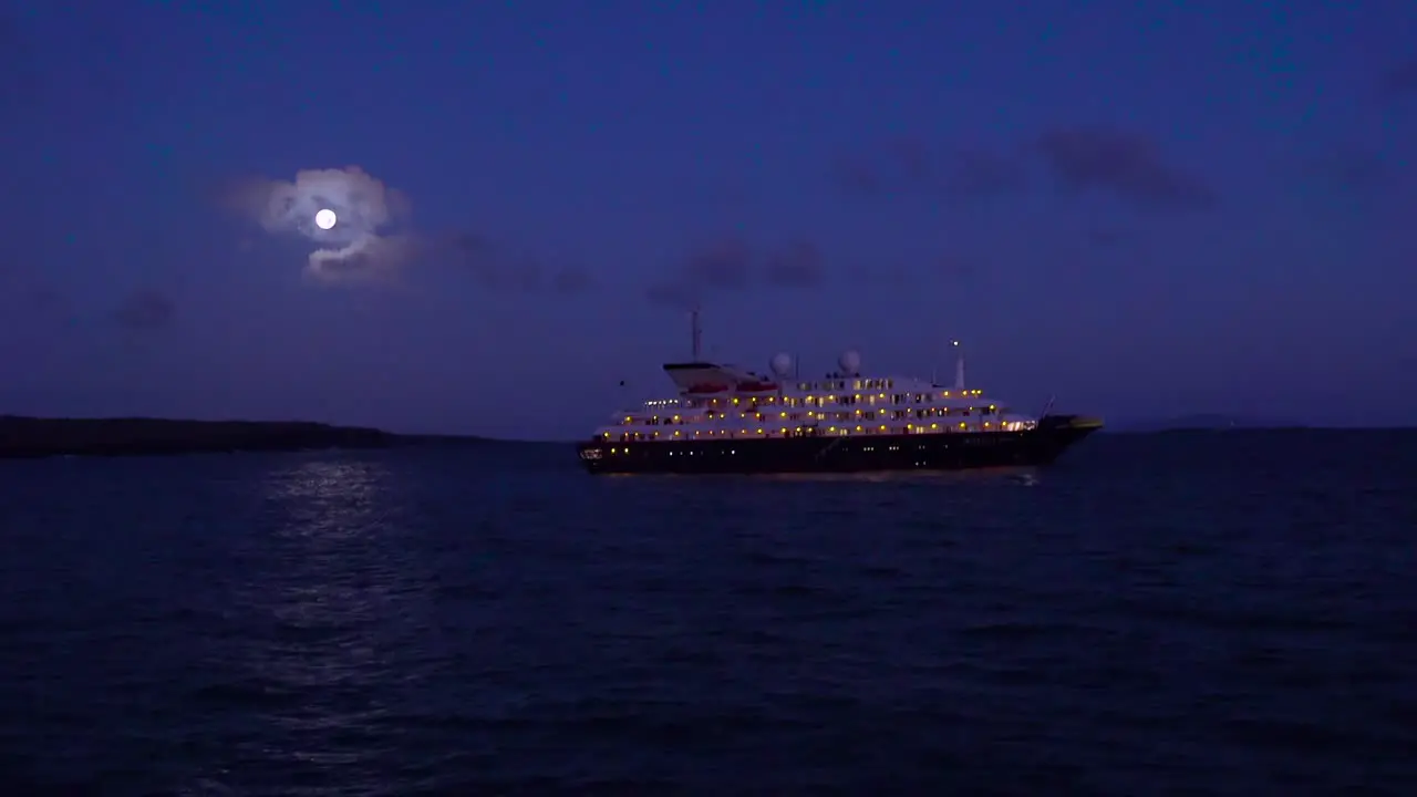 A ship sails on the sea in the moonlight