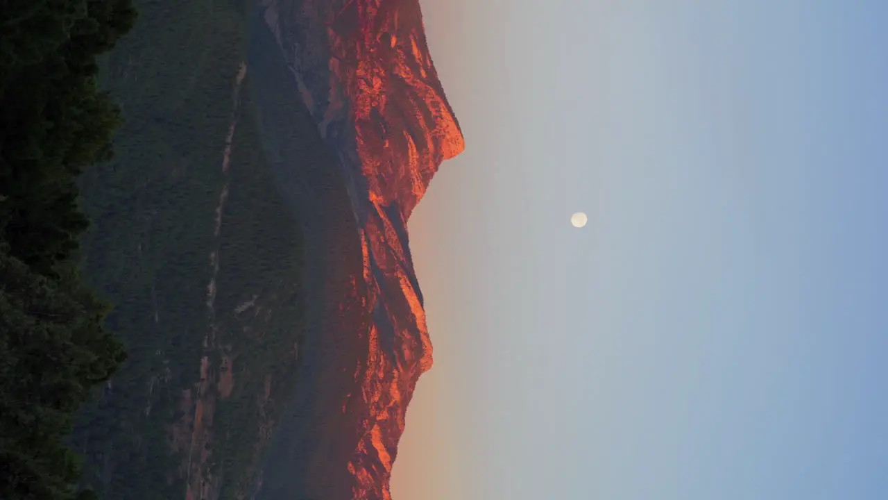 View of the penyagolosa peak during sunset with the full moon