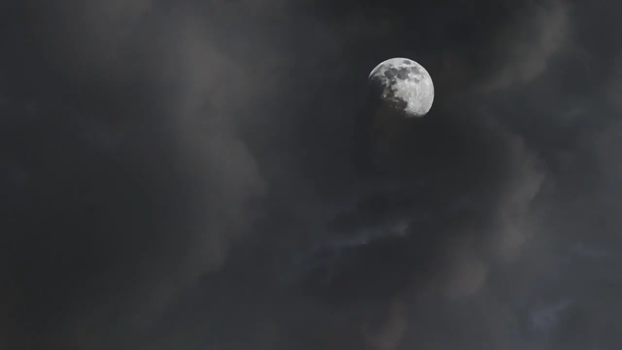 moon at night with dark clouds in the sky