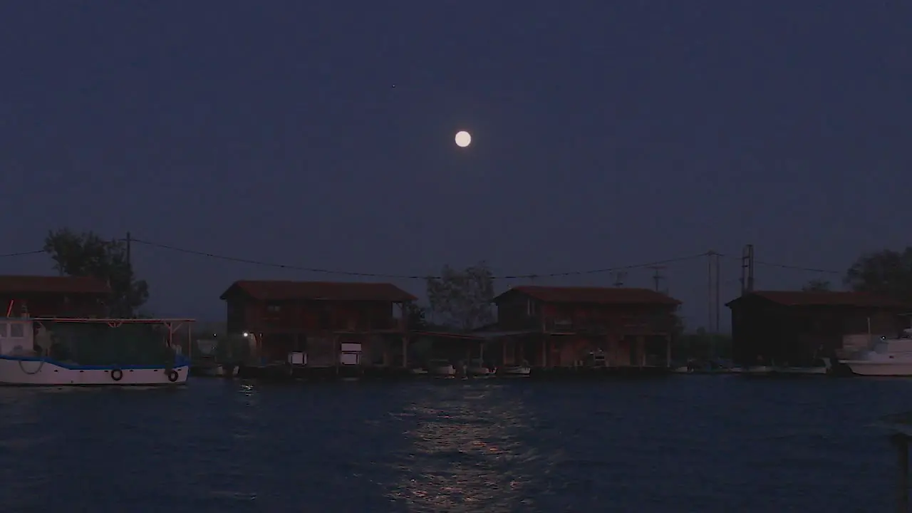 Full moon over Mussel with night fishermen