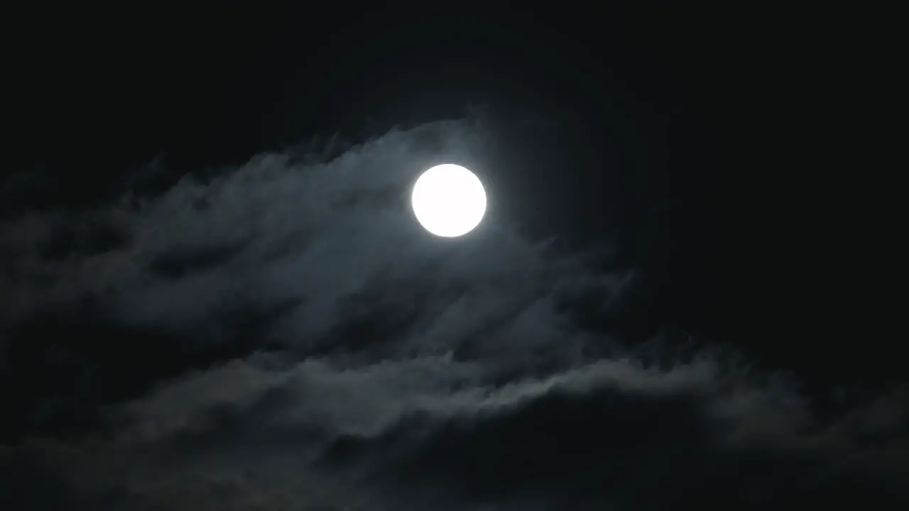 Clouds Passing In Front Of The Moon In The Night Sky low angle shot