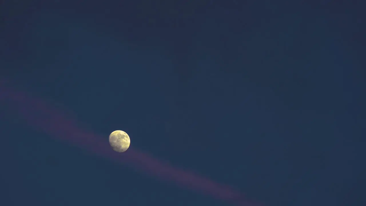 Pink Ribbon Cloud Floating by Waxing Gibbous Moon at Dusk