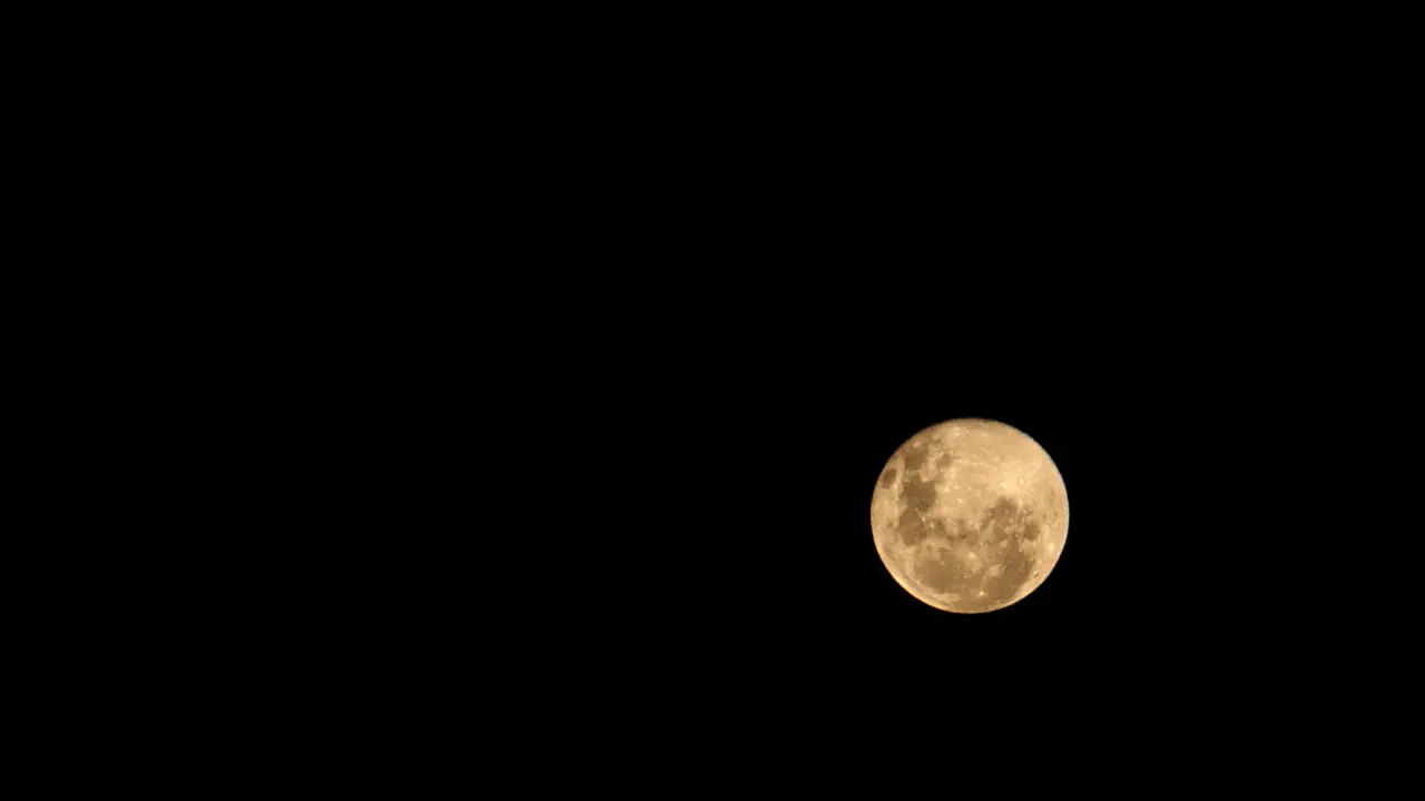 Orange Full moon moonrise time lapse pitch black dark night background