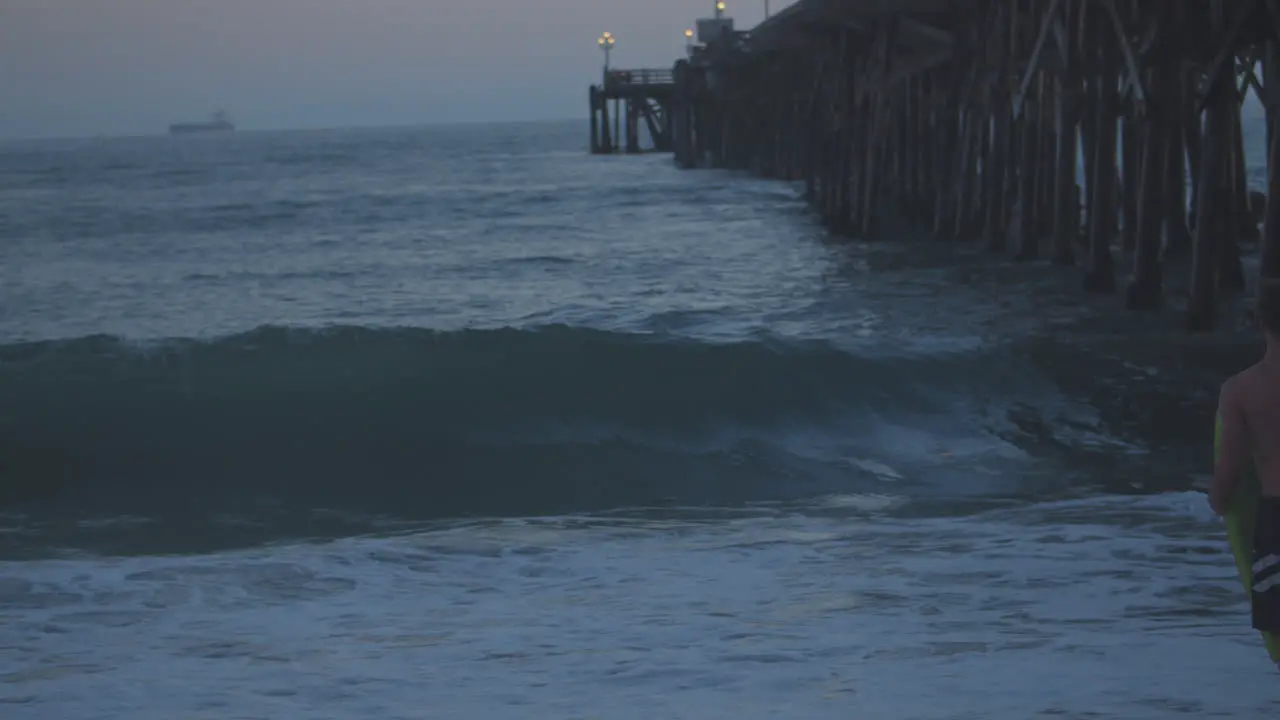 A young man watches Pacific waves