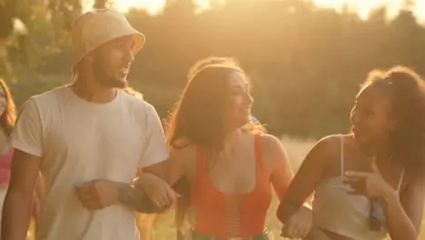 Tracking Shot of a Group of Friends Walking at Sunset