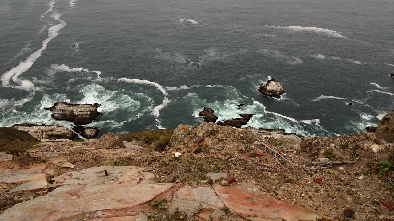 Sliding shot peering over the edge of a Point Reyes cliff to the ocean below