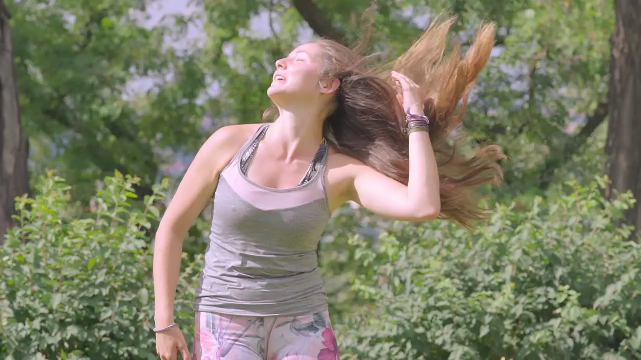 Young Female In Sportswear Flicking Her Long Hair Over Shoulder In Slow Motion