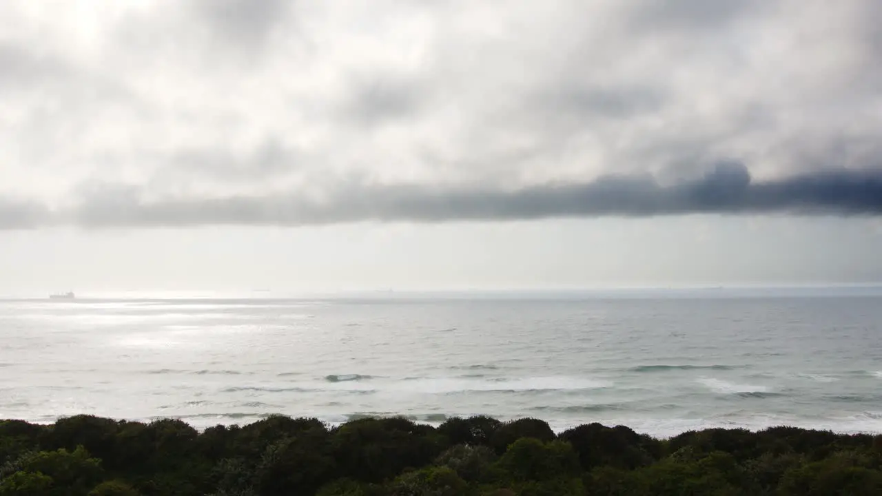 A high vantage point of the ocean with waves crashing and a ship on the horizon heavy could cover