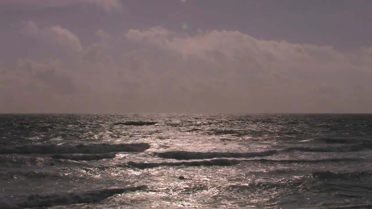 Choppy waves continuously break and roll onto shore 