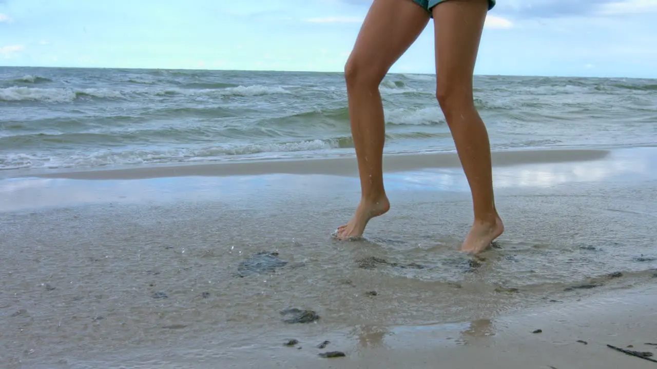 A woman playing alone with at the ocean in summertime