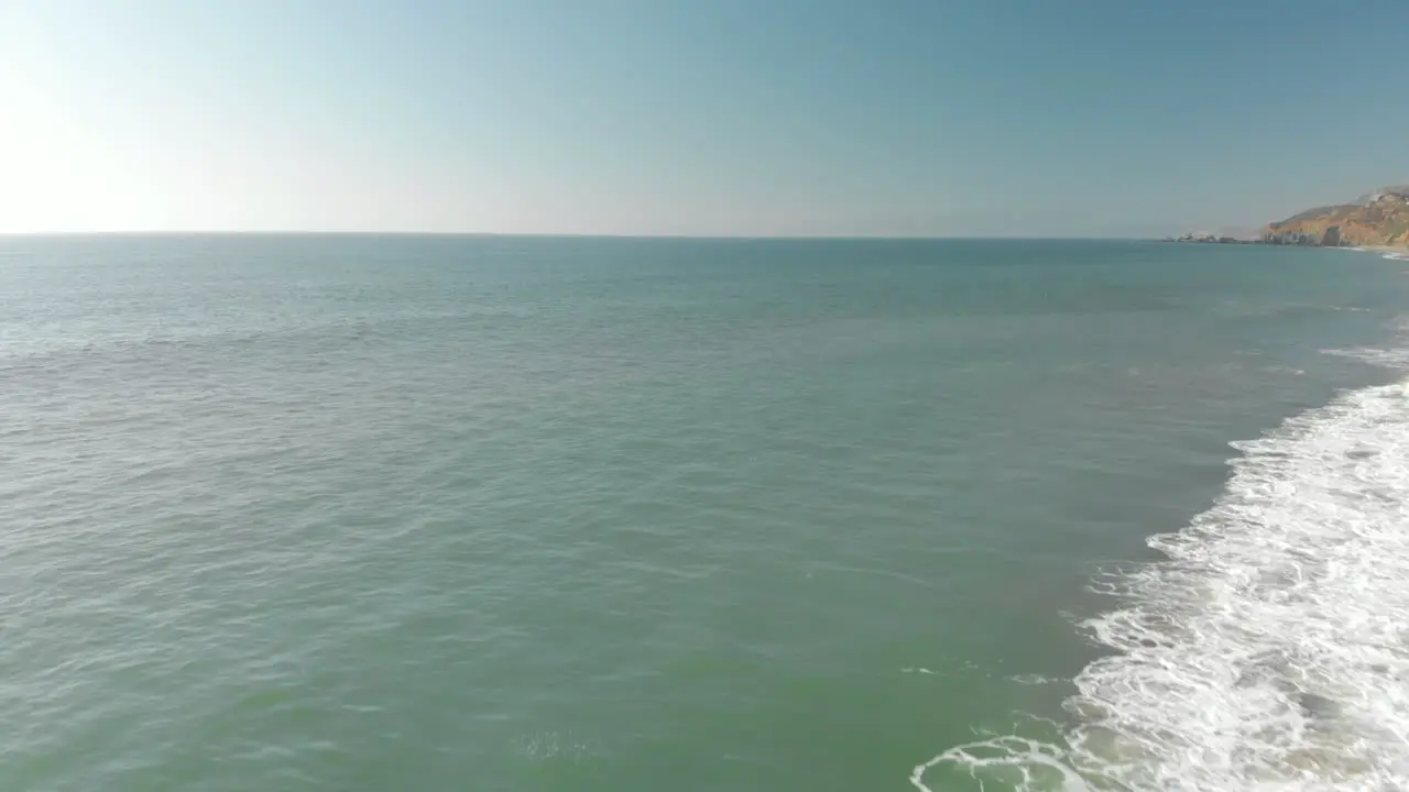 Aerial of Low Wave Crashing on Shore