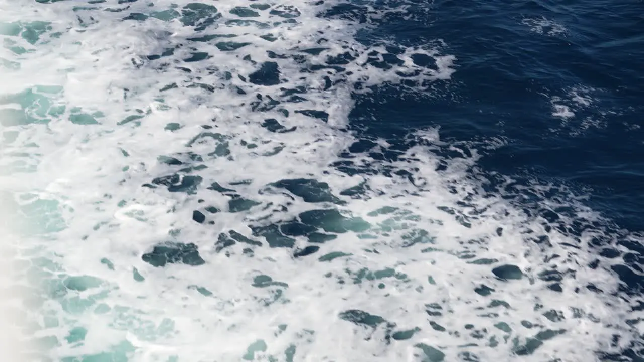 Slow motion view of the wake water trace behind a ferry at sea