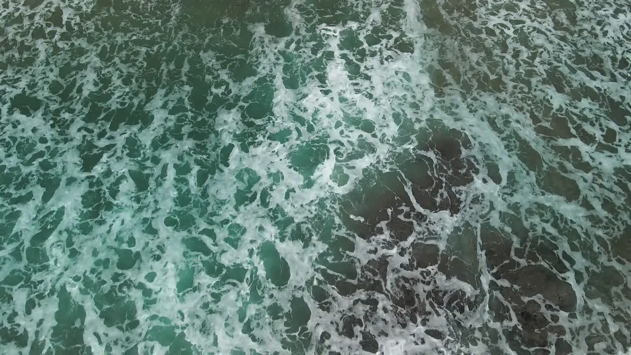 Tide washing out with aerial view of sand