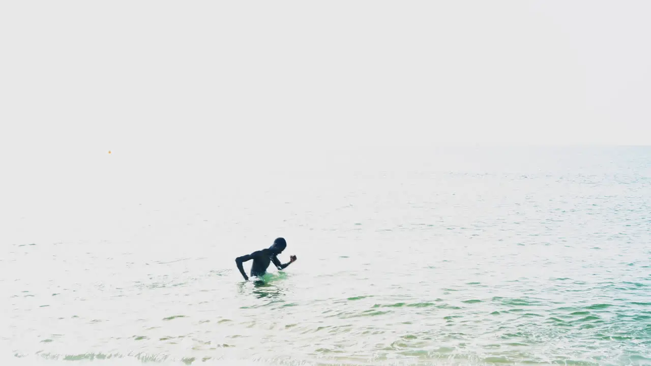 Professional black football player doing an aqua workout in the sea of Barcelona