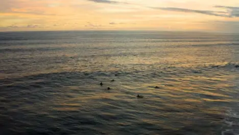 Drone Shot Pulling Away from Group of Surfers Waiting for Wave 