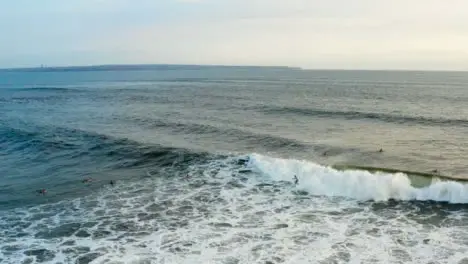 Drone Shot Following a Surfer Riding Wave 