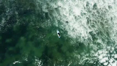 Rotating Drone Shot Looking Down On People In Ocean Off of Canggu Coast