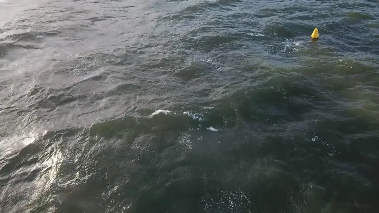 Drone aerial over ocean Melbourne wavy windy cloudy day with man swimming in water