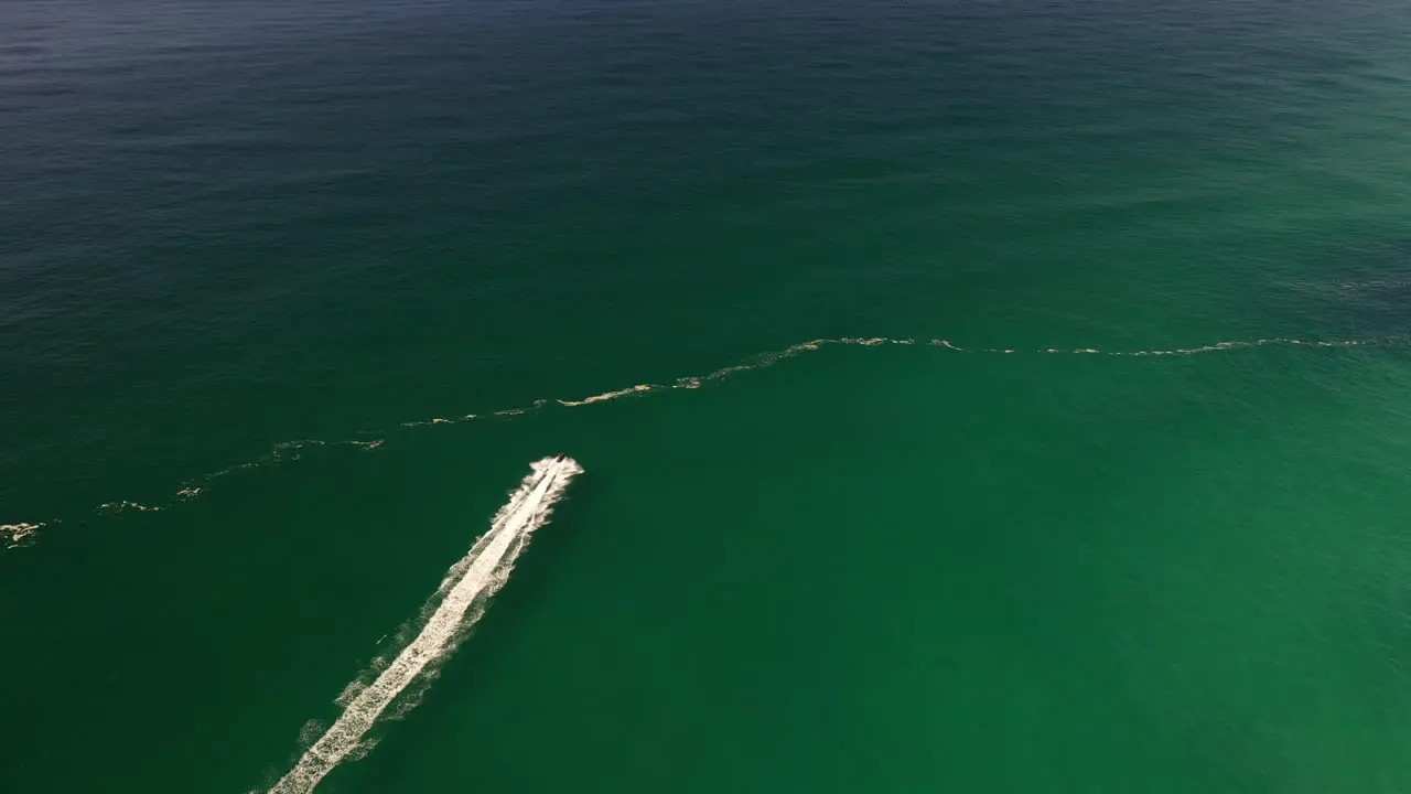 A jetski is seen riding through a stunning oceanside location off the Australian Coast