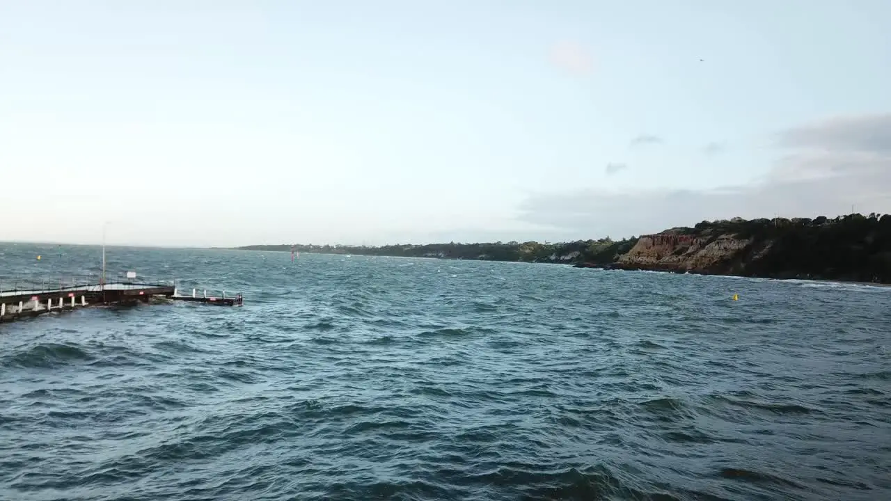 Drone aerial over ocean Melbourne wavy windy cloudy day with blue water