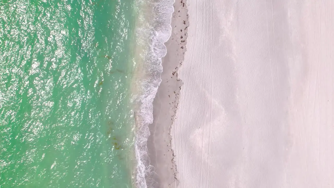 Aerial top view of ocean blue waves break