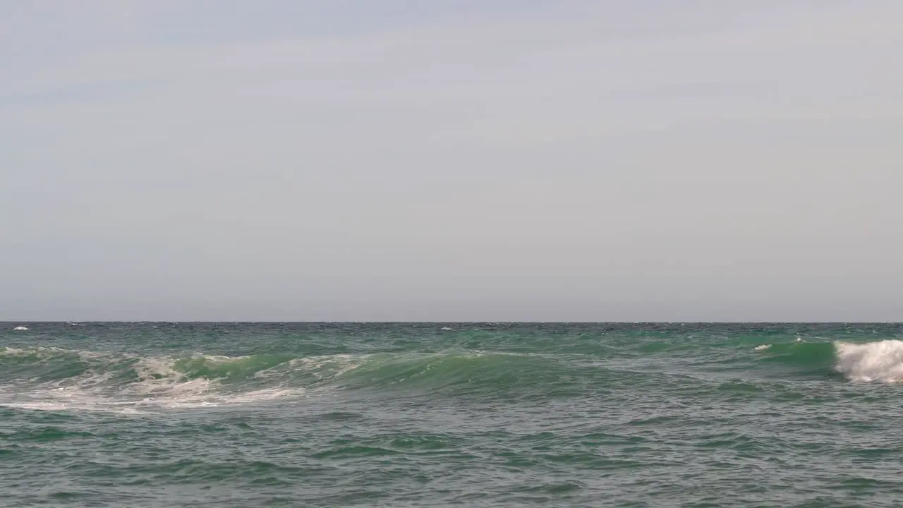 Minimal low angle view out towards ocean with waves crashing