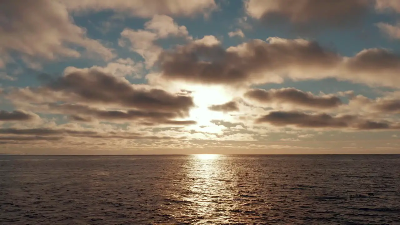 Epic aerial view of golden sunset sunrise at sea with strong reflection