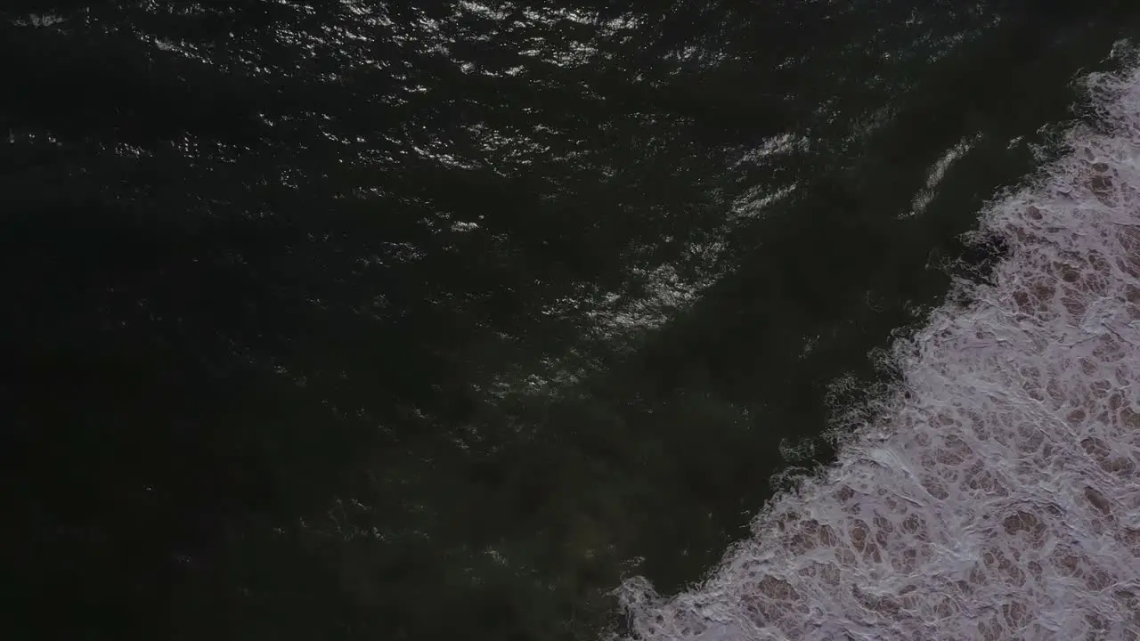 Aerial clip bird's eye view that shows the sea and its waves at the end it makes a panoramic view of the horizon