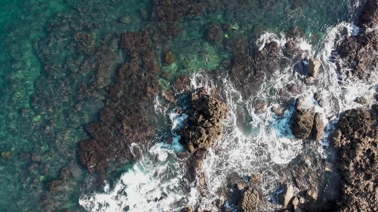 AERIAL waves are gently rolling into the rocks in Portugal