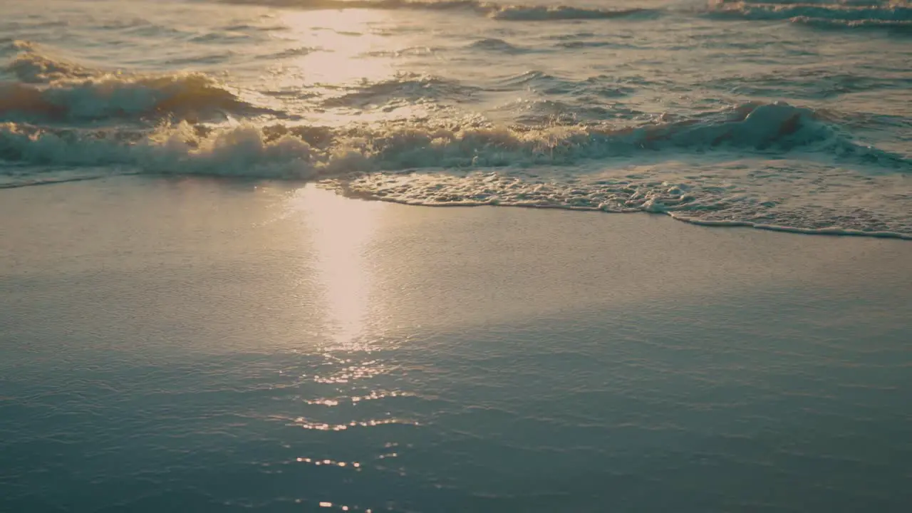 Waves on beach during sunset slow motion