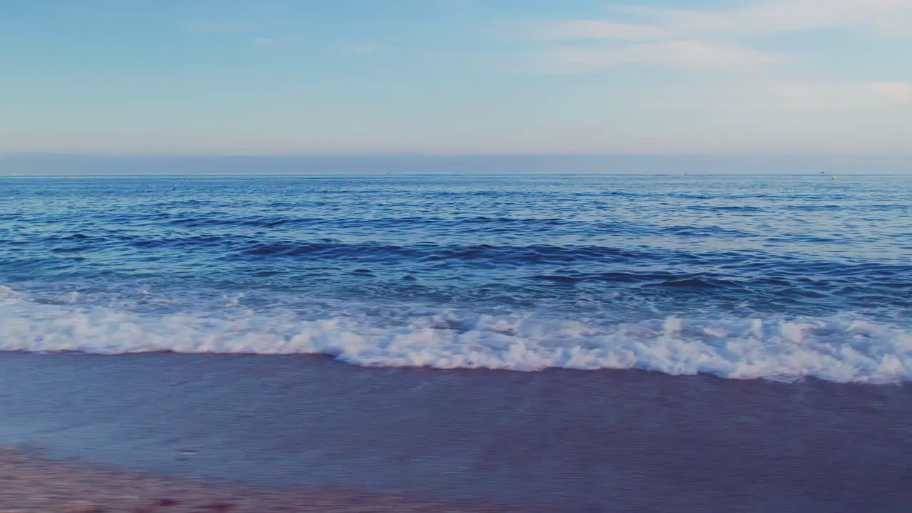 Drone flying in circle at the beach near the sea and during sunset