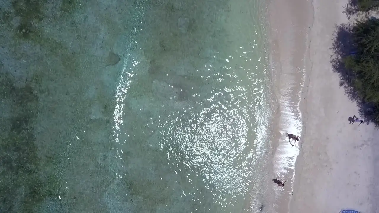 walk on the beach lying on colorful blankets Wonderful aerial view flight bird's eye view drone footage of Gili T beach bali Indonesia at sunny summer 2017 Cinematic view from above by Philipp Marnitz