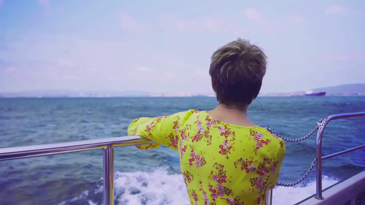 Slow motion shot of woman looking at the view from the boat