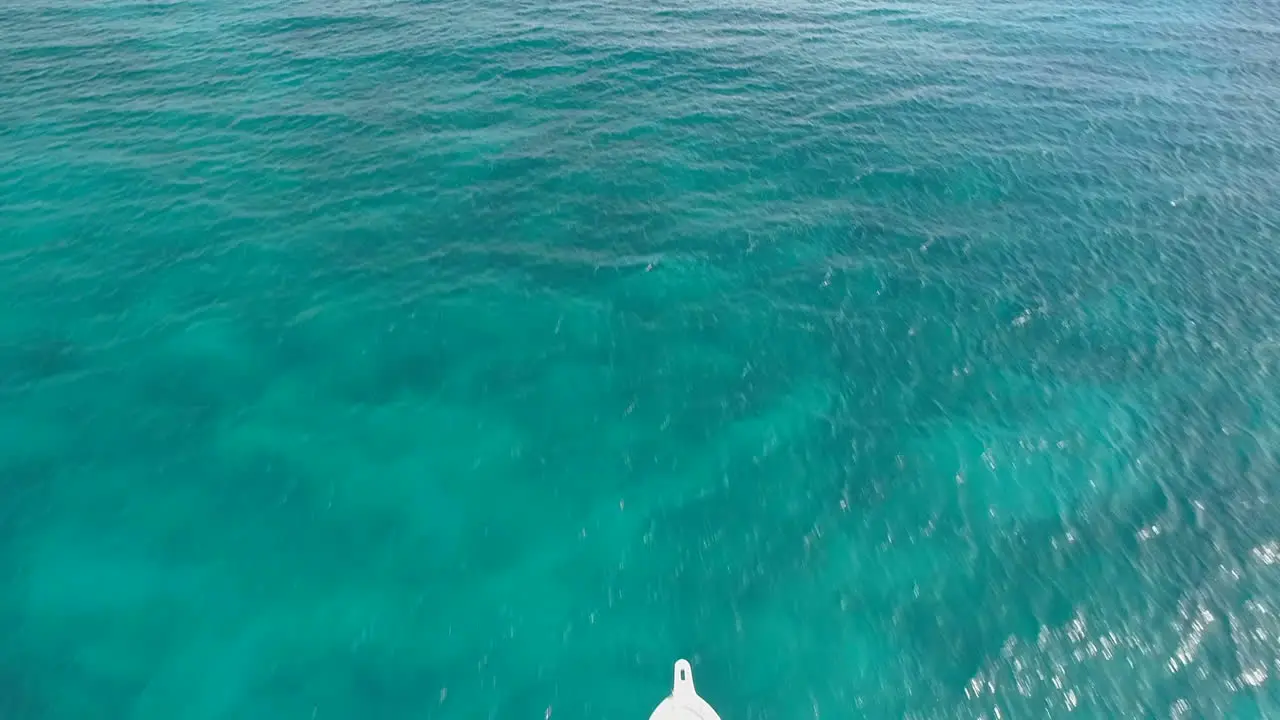 Aerial forward over tourist speedboat navigating on turquoise sea water