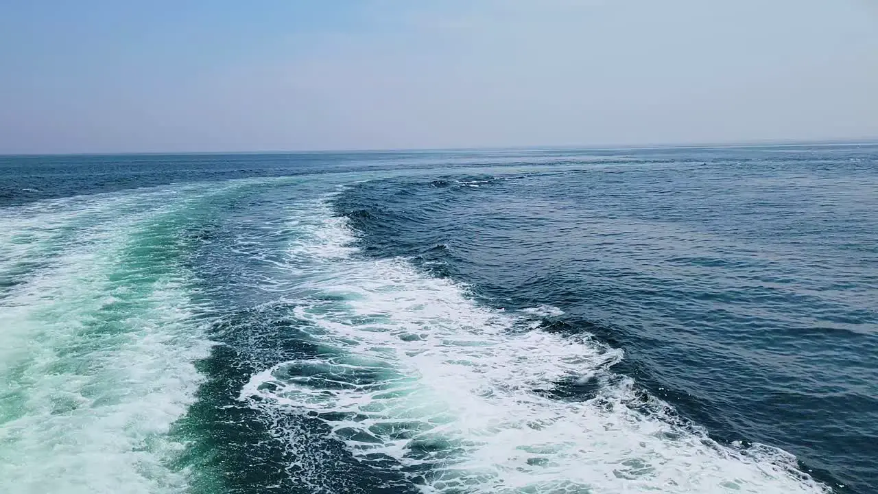 Wake On Turquoise Ocean Surface Created By A Sailing Ship