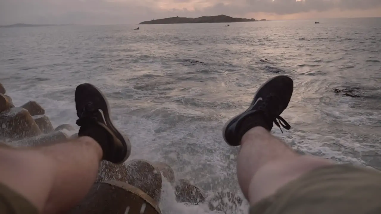 First person view POV watching the sun set into the Atlantic Ocean in port city of Essaouira Morocco