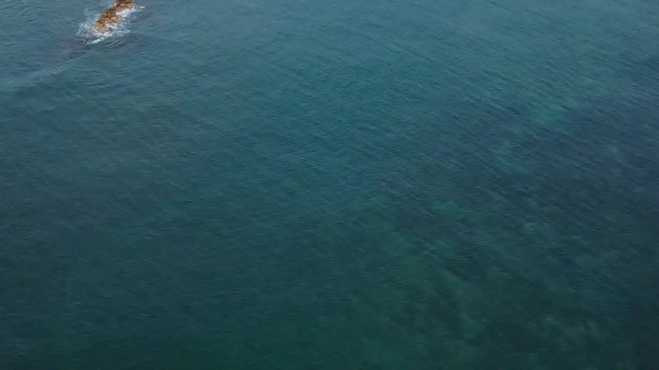 Drone aerial pan down surfers waves Hawaii