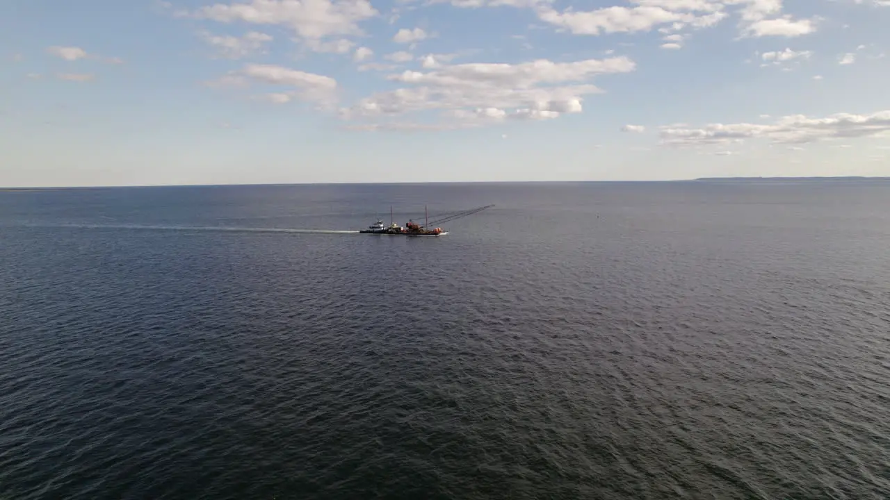 Aerial Flying Towards Floating Crane Platform Being Pushed By Tug Boat Off Coney Island New York