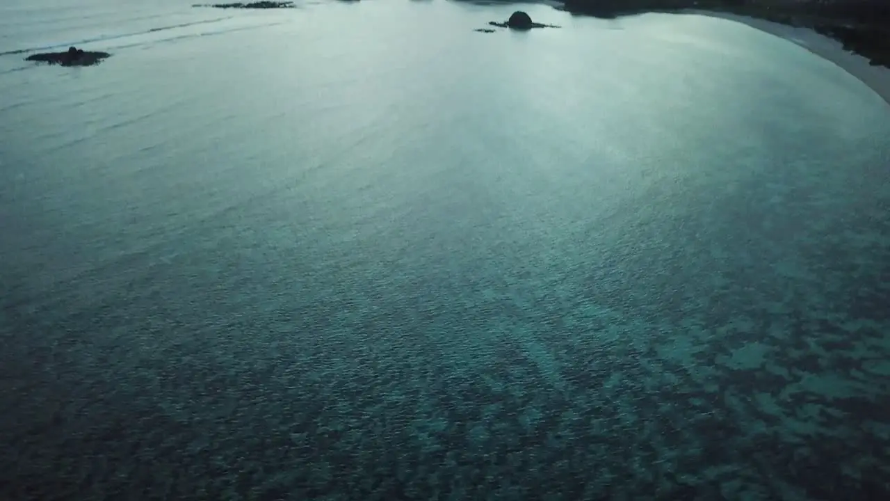 AERIAL 4K High Panning Shot Over Clear Blue Waters at Sunset in Indonesia